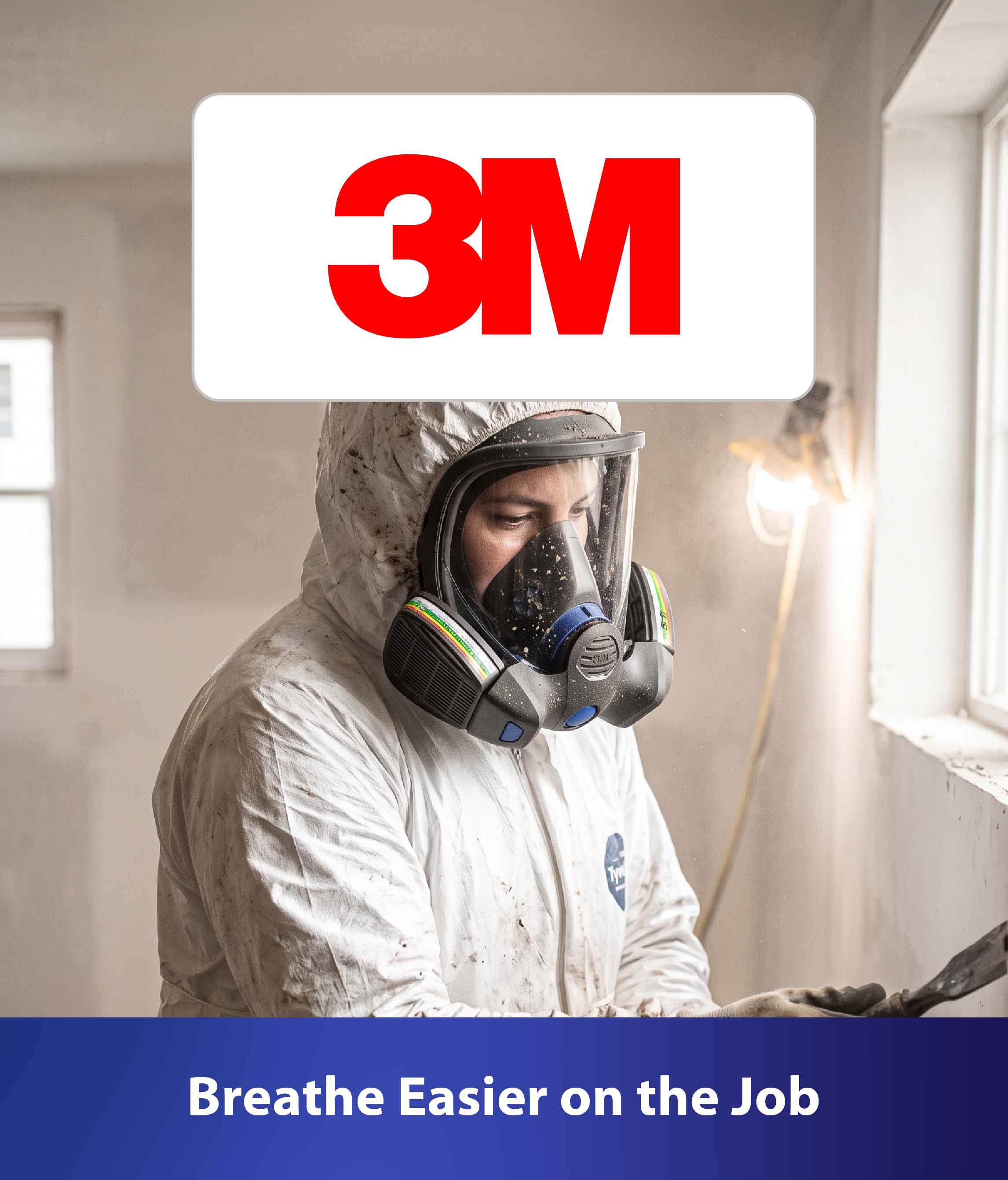 Worker wearing protective coveralls and a full-face respirator indoors